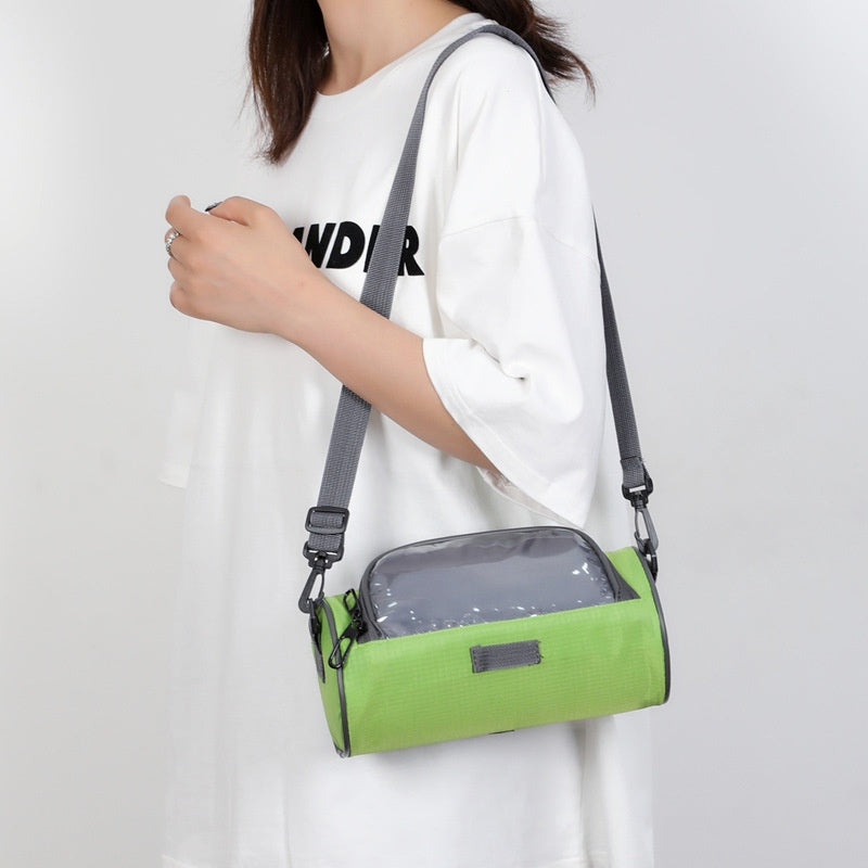 Green handlebar bag worn with shoulder strap